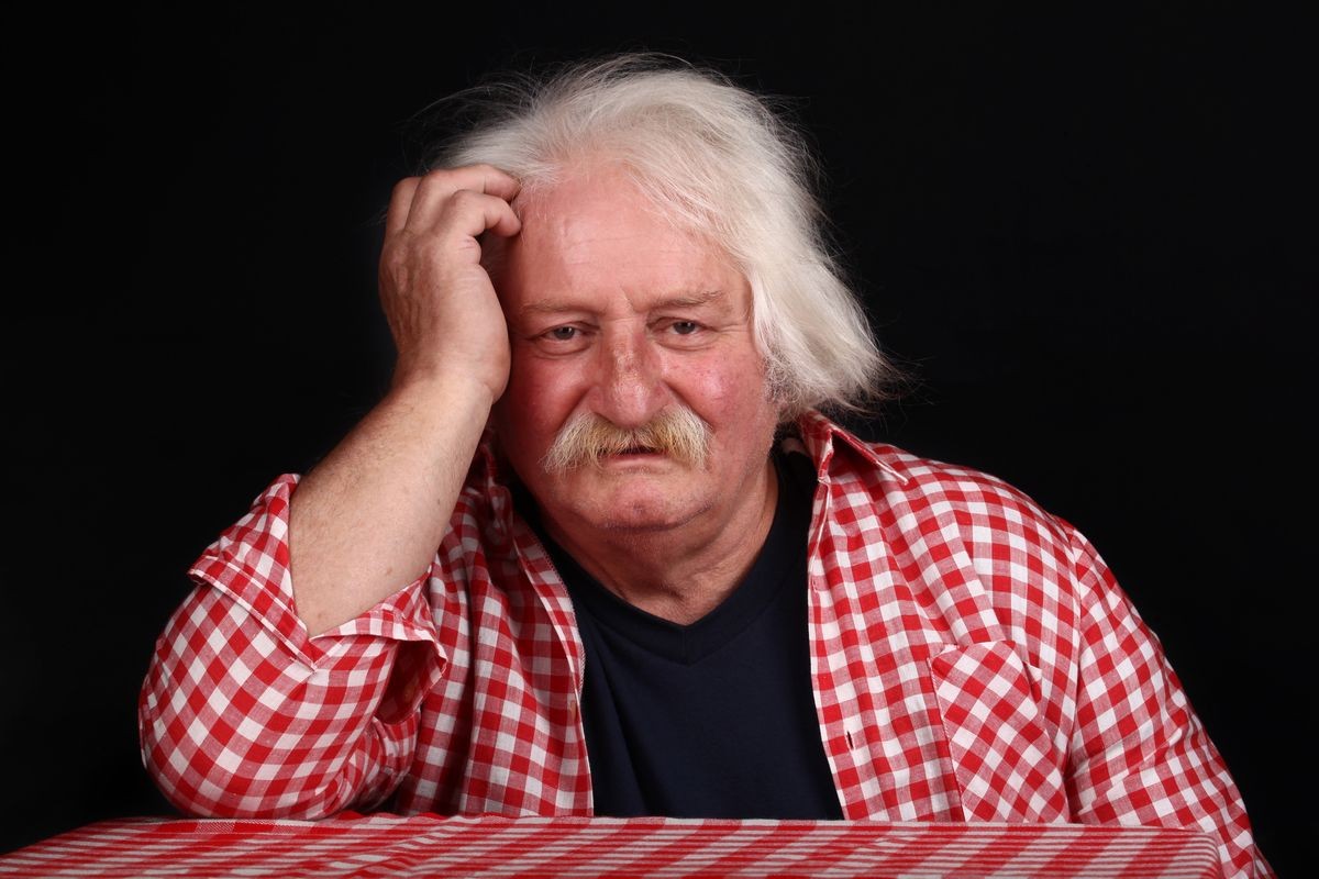 Portrait of elderly man with headaches and depression